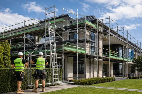 Monument Scaffolding crew installing full perimeter scaffolding on a two-storey residential home