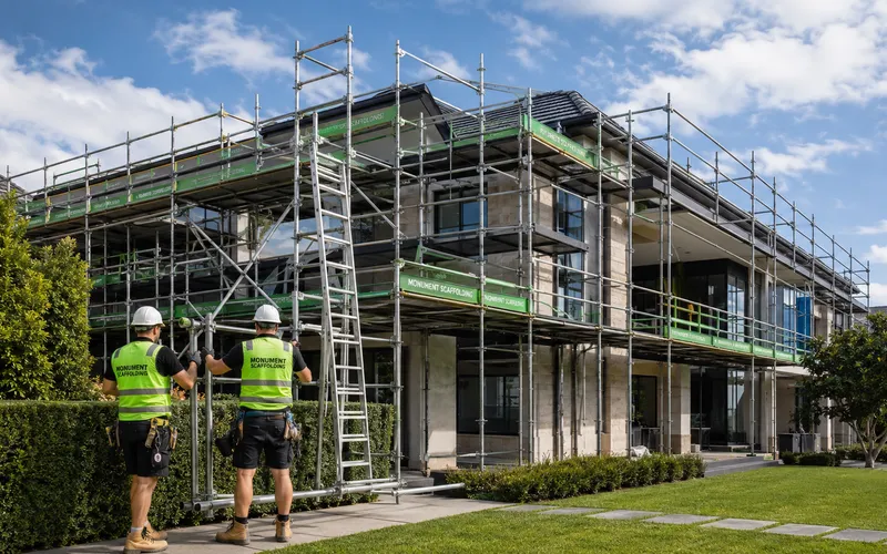 Monument Scaffolding crew installing full perimeter scaffolding on a two-storey residential home
